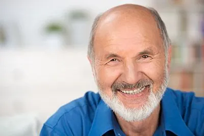 man showing off his newly restored smile thanks to services from Afdent in Fort Wayne, IN