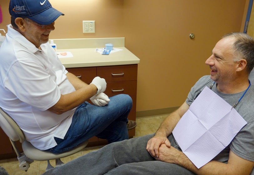 Dr. Pecina discussing dental treatment options with a patient at Afdent in Fort Wayne, IN